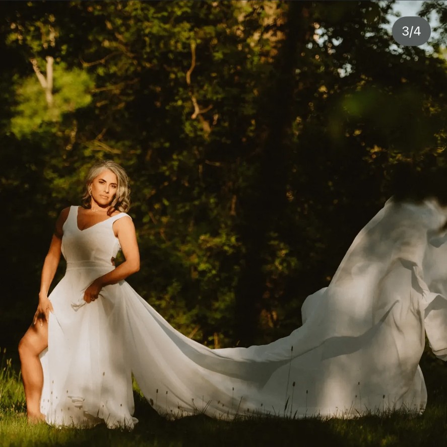 Marisol in a flowing white gown in the forest