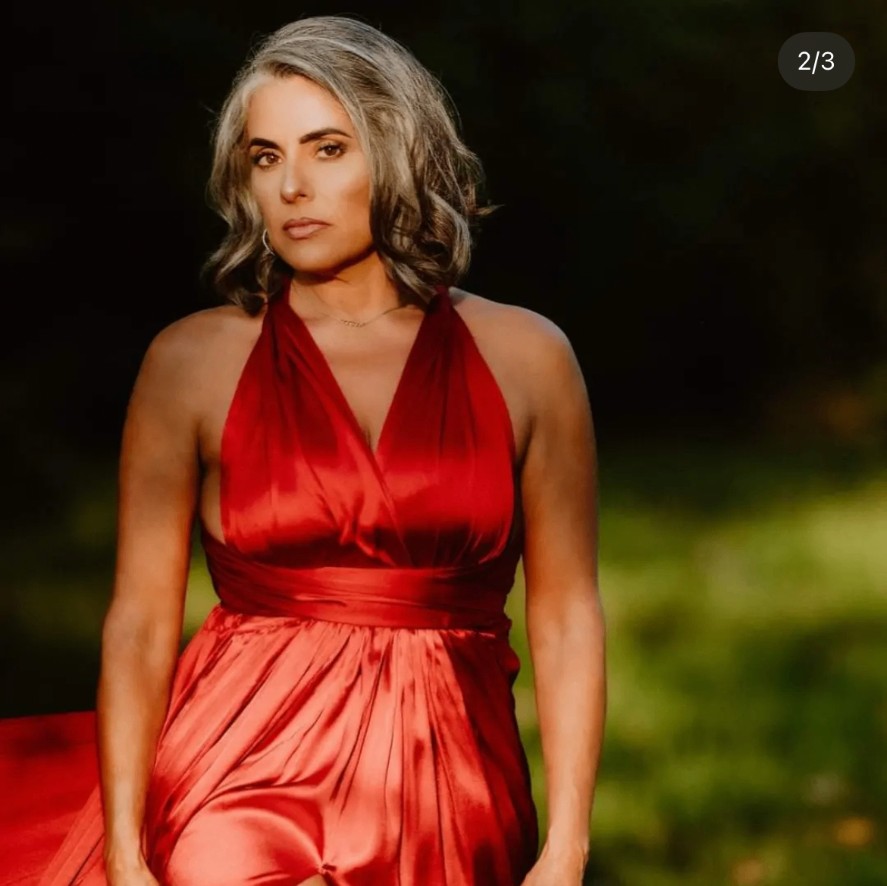 Marisol in a red dress